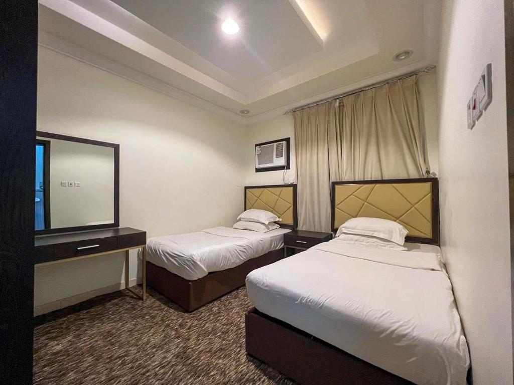 Postel nebo postele na pokoji v ubytování Malfa SERVICED APARTMENTS