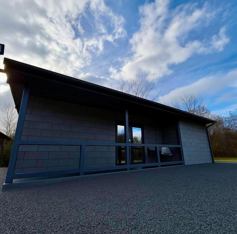 a large white building with windows on the side of it at Secret Forest Avrig By Erwin in Avrig