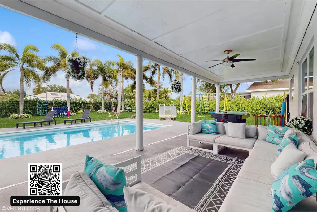 a patio with a pool and a ceiling fan at Kids and Family Playground in Wellington