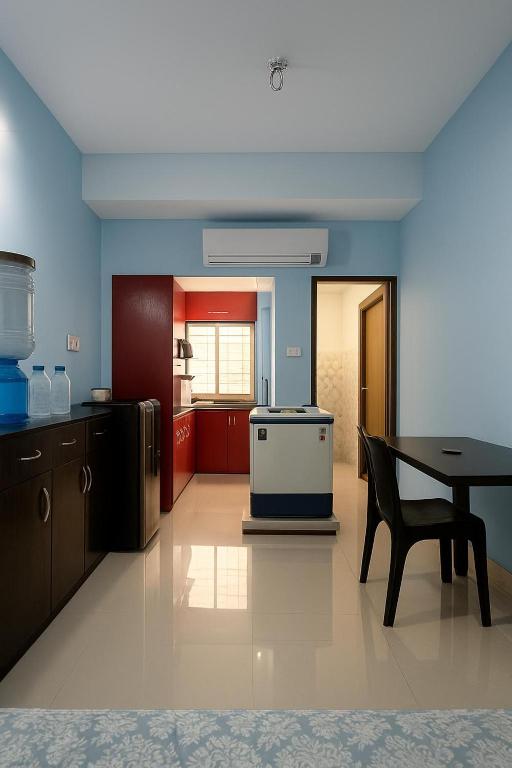 a kitchen with a table and a stove in it at Fully furnished 2 BHK Flat in kolkata