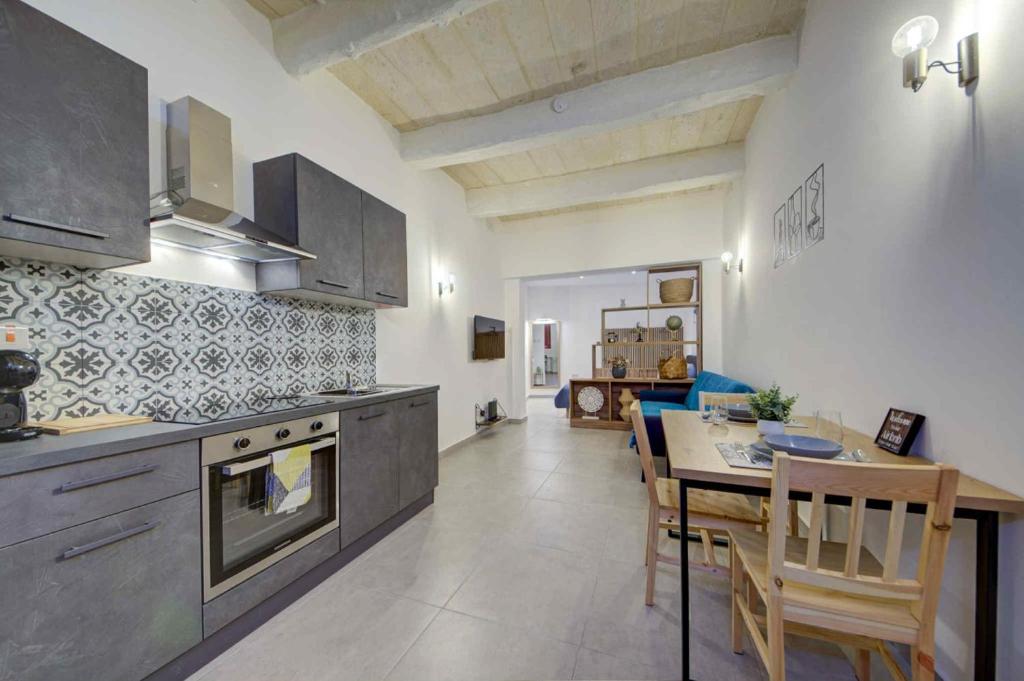 a kitchen with a table and a dining room at Charming Rabat Studio Stay in Rabat