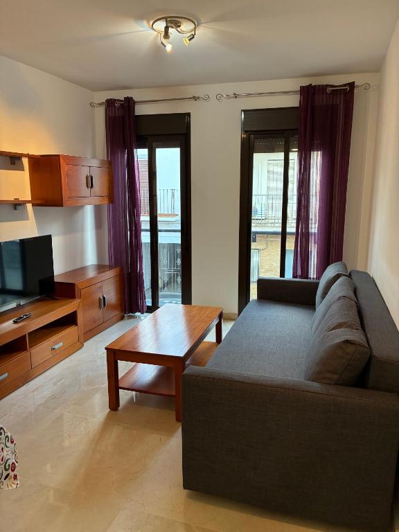 a living room with a couch and a table at Centro a todo confort, 1 dormitorio A in Dos Hermanas
