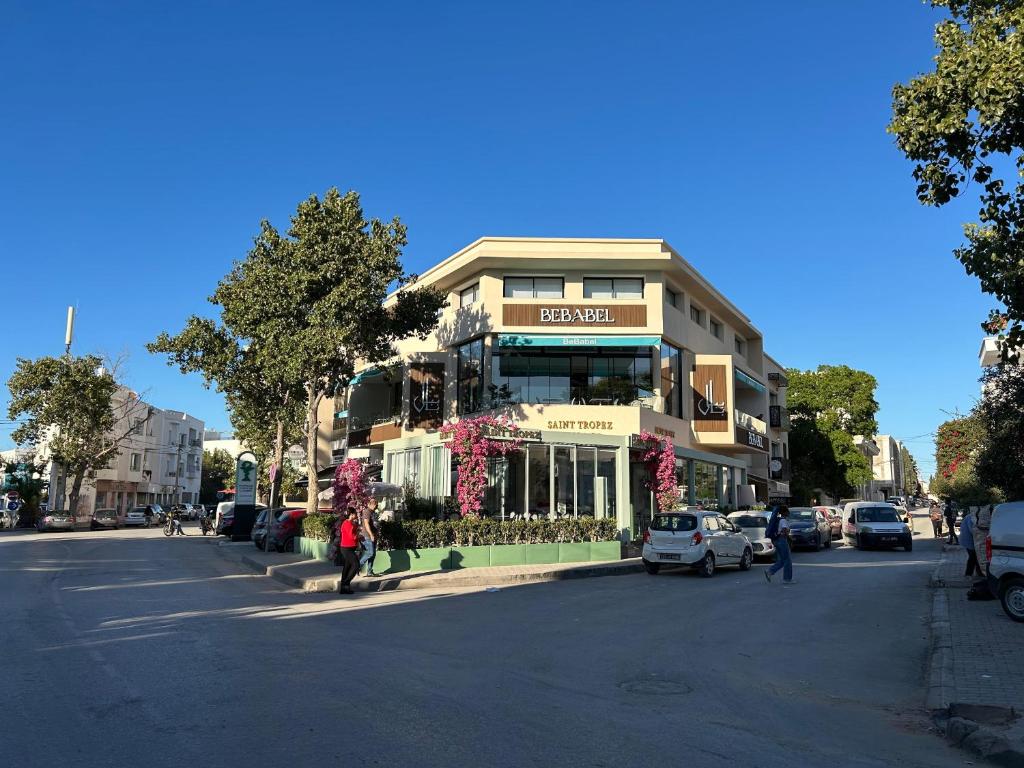 a building on the corner of a street with cars parked at Ines House in La Marsa