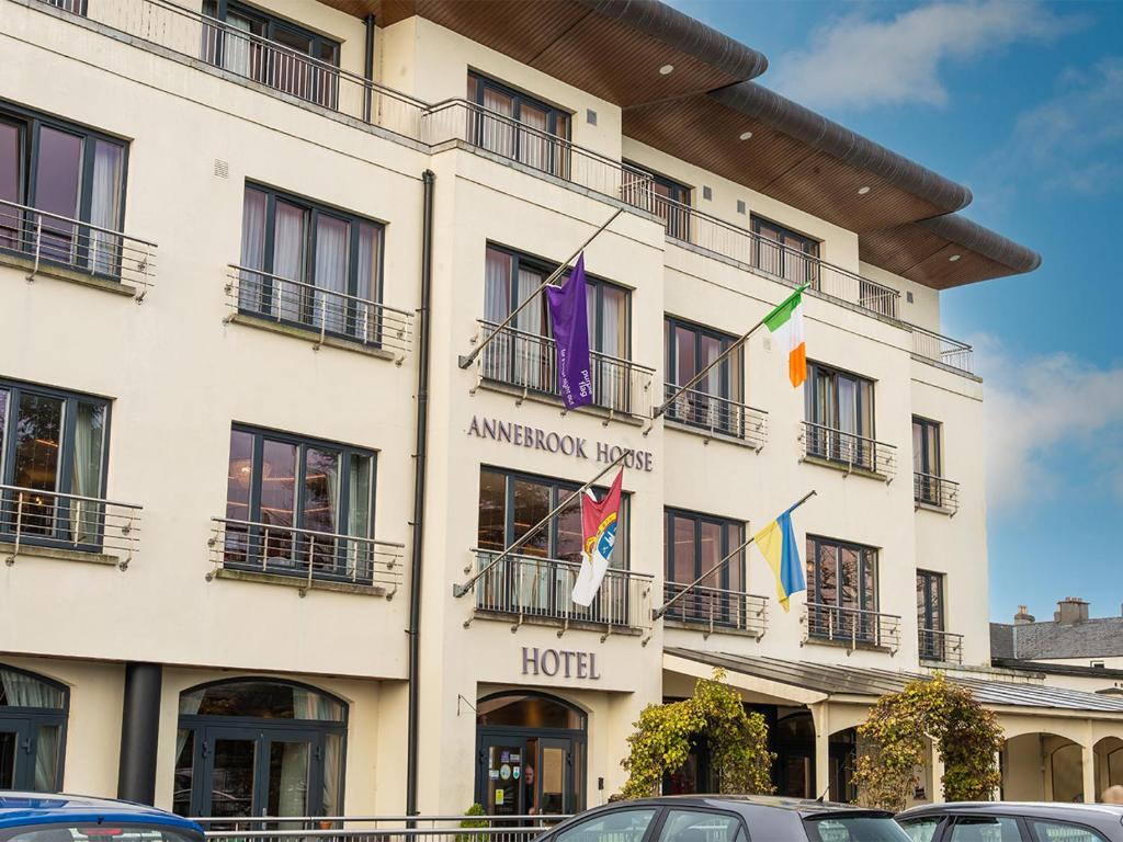 a hotel with flags on the front of it at Annebrook House Hotel in Mullingar
