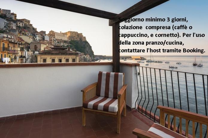 a chair sitting on a balcony overlooking the water at Casa di Sale - Chianalea in Scilla