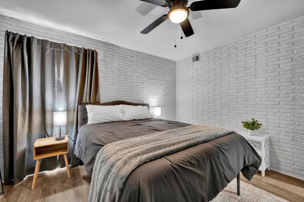 a bedroom with a bed and a ceiling fan at Near Boomer Lake & OSU - Relaxing Retreat in Stillwater