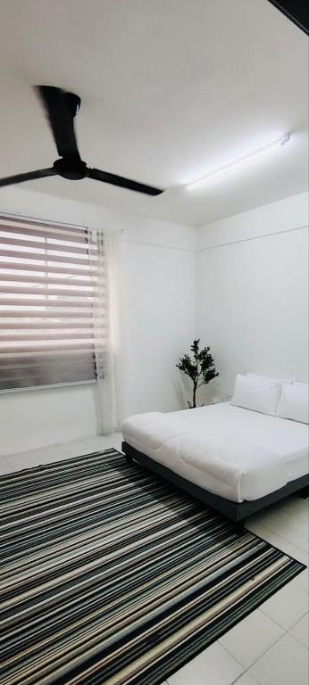 a white bedroom with a bed and a window at HomestayFA in Gua Sai