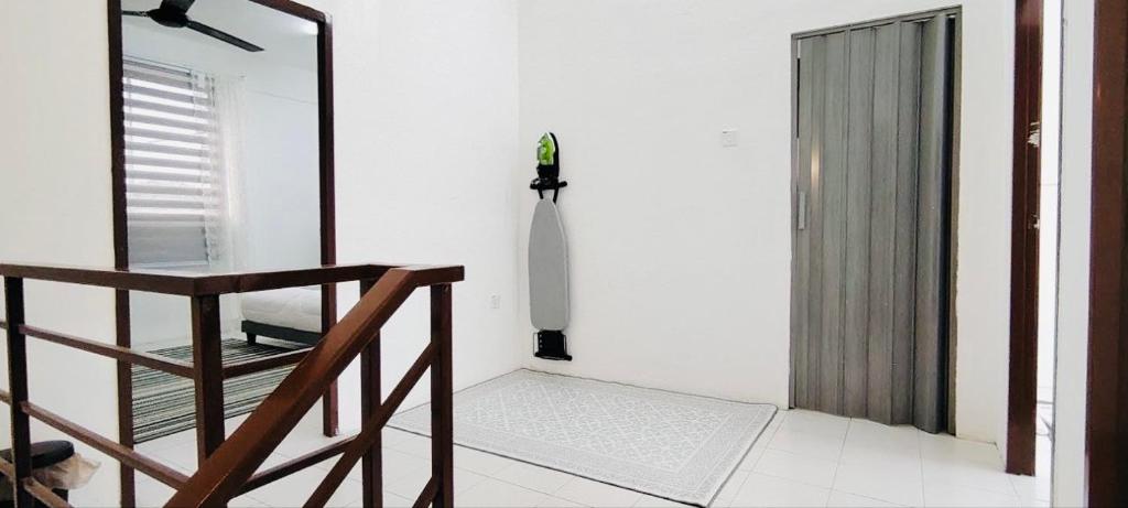 a room with a mirror and a staircase and a door at HomestayFA in Gua Sai