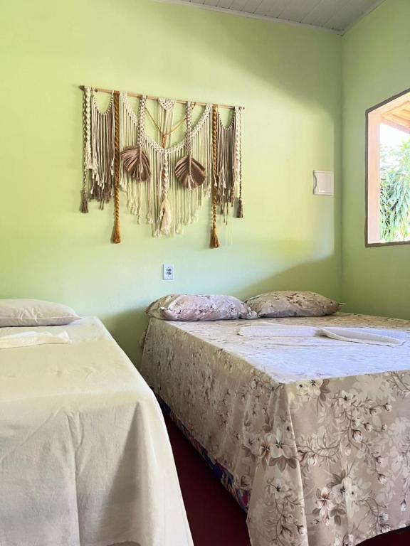 Ένα ή περισσότερα κρεβάτια σε δωμάτιο στο Chalé Ilha Verde-Cumuruxatiba