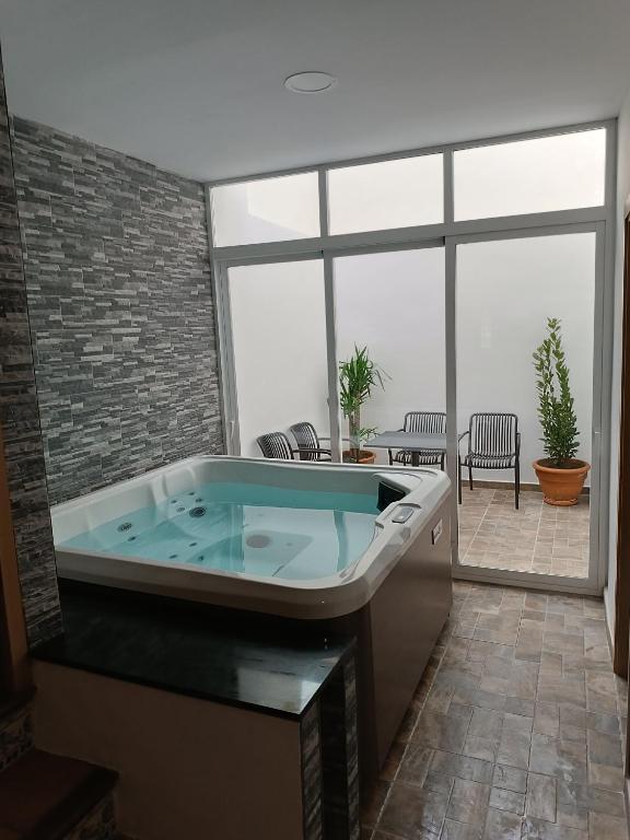 a jacuzzi tub in a room with a patio at Casa Caldereta in Ayelo de Rugat