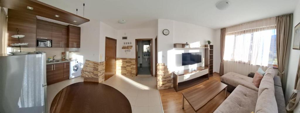 a living room with a couch and a television at Апартаменты в Belvedere in Bansko