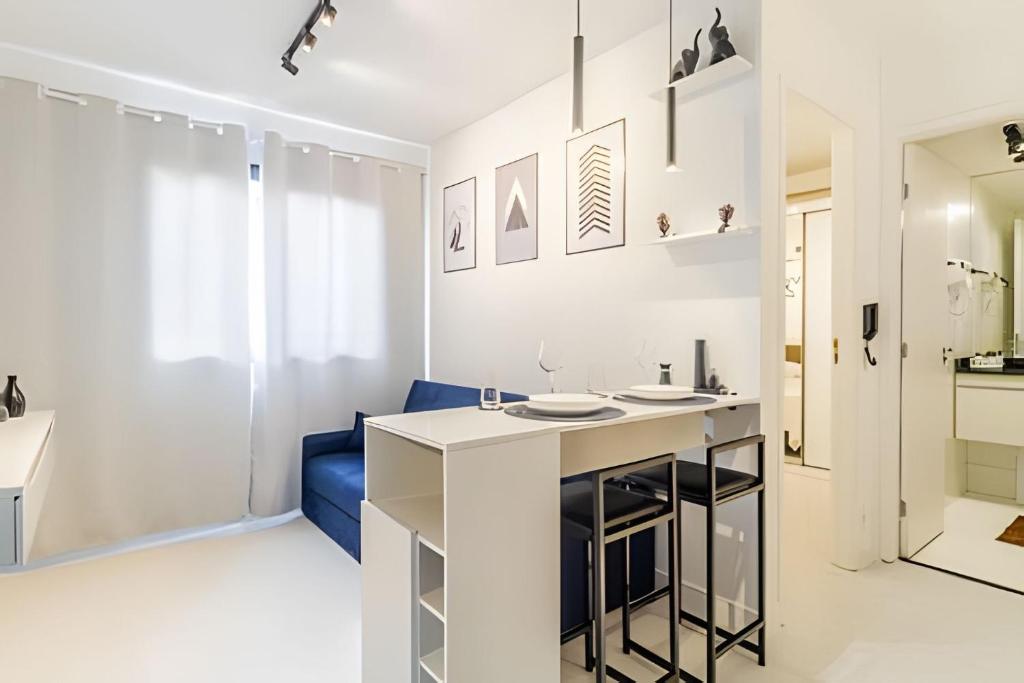 a white bathroom with a counter and a blue couch at BRIG903 - Apartamento Av Brigadeiro Próximo à Paulista, Bela Vista in Sao Paulo