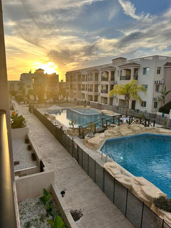 a resort with two swimming pools and some buildings at Royal Seacrest F 103 in Paphos