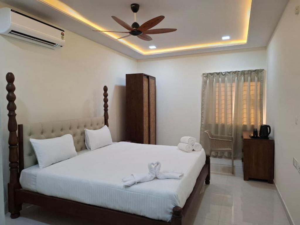 a bedroom with a bed with a ceiling fan at Farm Stay Genome in Jāmb