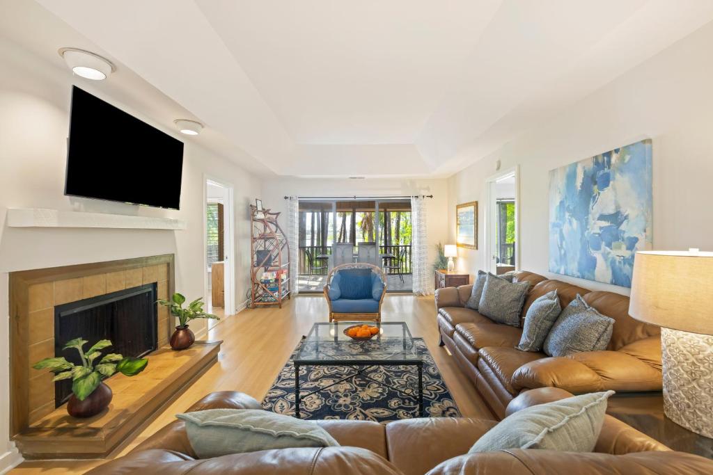 a living room with a couch and a fireplace at IC50: 50 Inlet Cove in Kiawah Island