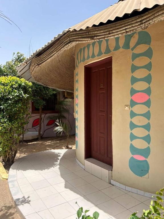 a small house with a brown door on it at Maison Kerniko in Warang