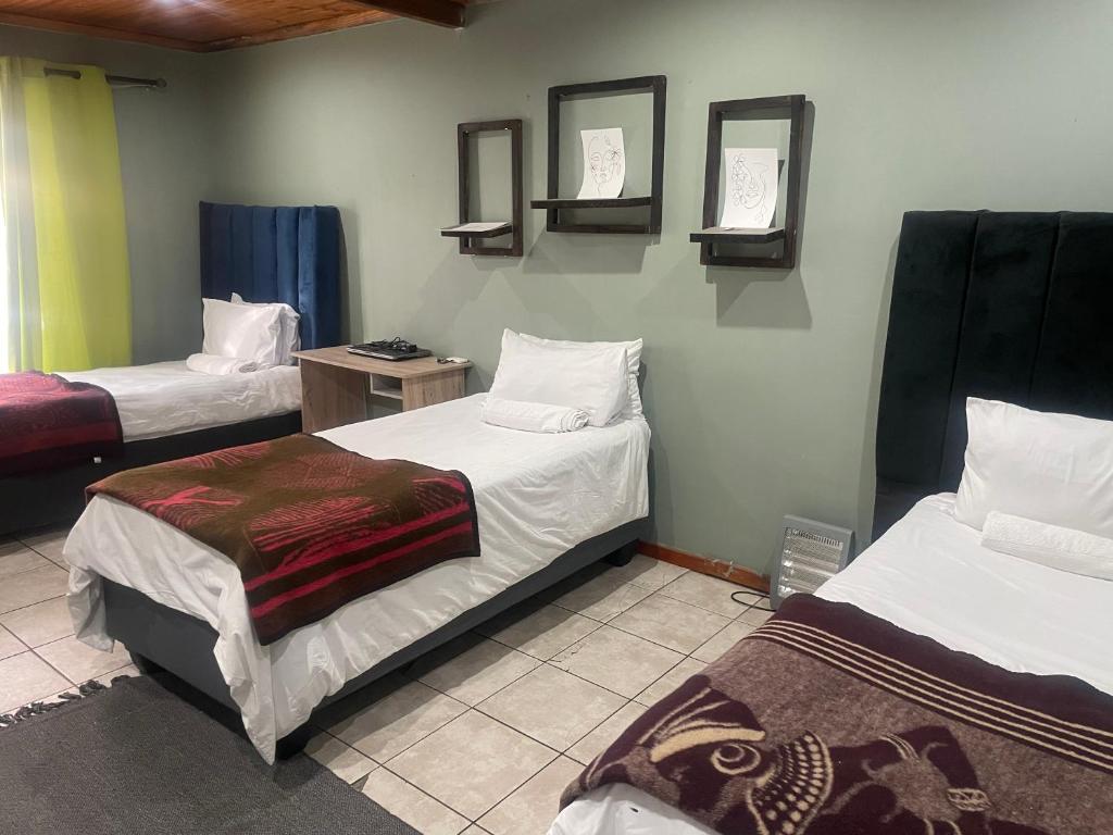 a room with two beds and two mirrors on the wall at VB Accomodation (STATION HOME) in Cape Town