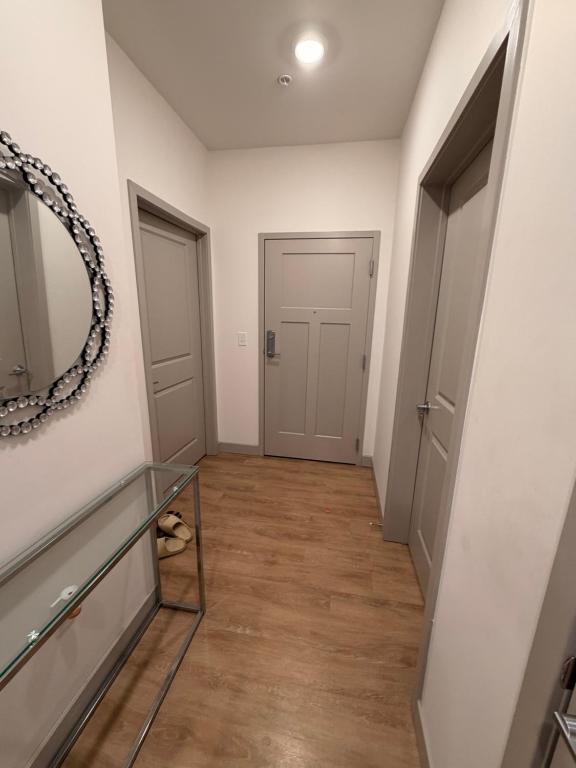 an empty hallway with a mirror and a door at Modern Midtown Retreat Luxury Car Option in Kansas City