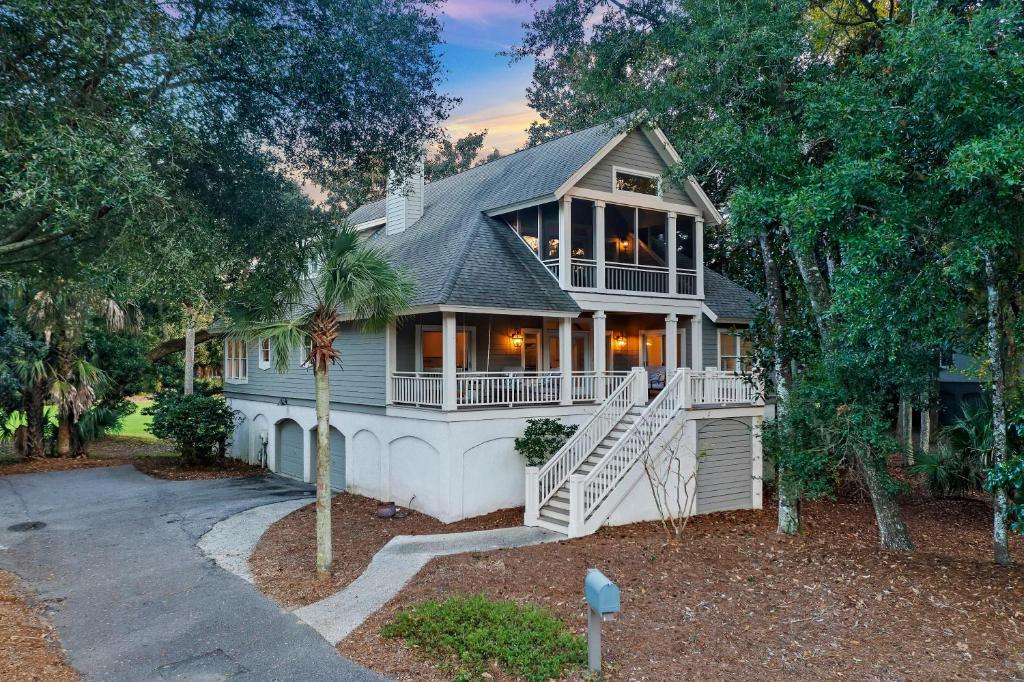 a large house with a porch and a staircase at OG18: 18 Ocean Green in Kiawah Island