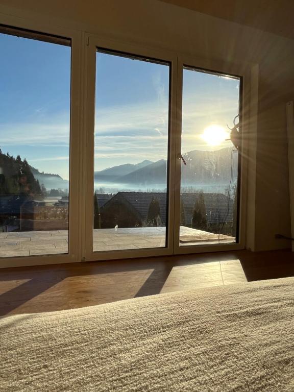 a bedroom with a large window with a view of the mountains at Apartment Laura in Jenig