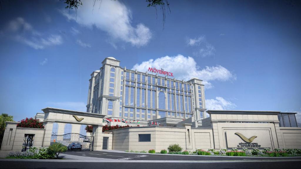 a hotel building with a sign on top of it at MOVENPICK HOTEL AL ZAYTOON BAGHDAD in Baghdad