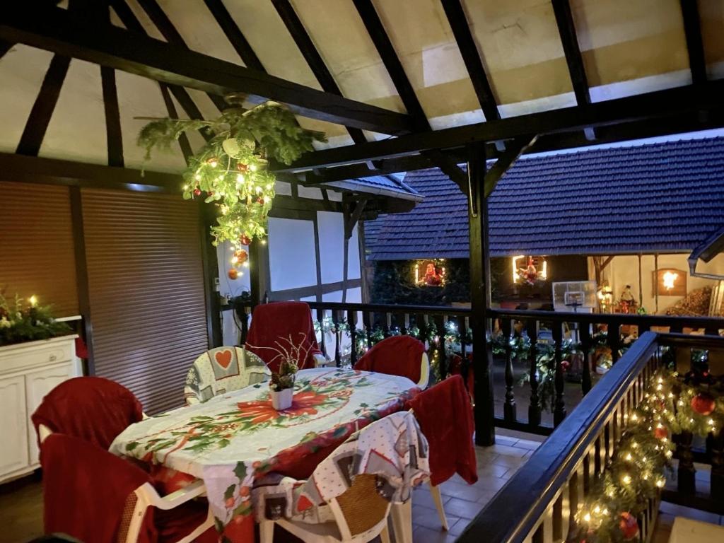 a table and chairs on a balcony with christmas lights at Appartement Aux Deux Cigognes Bis in Gries