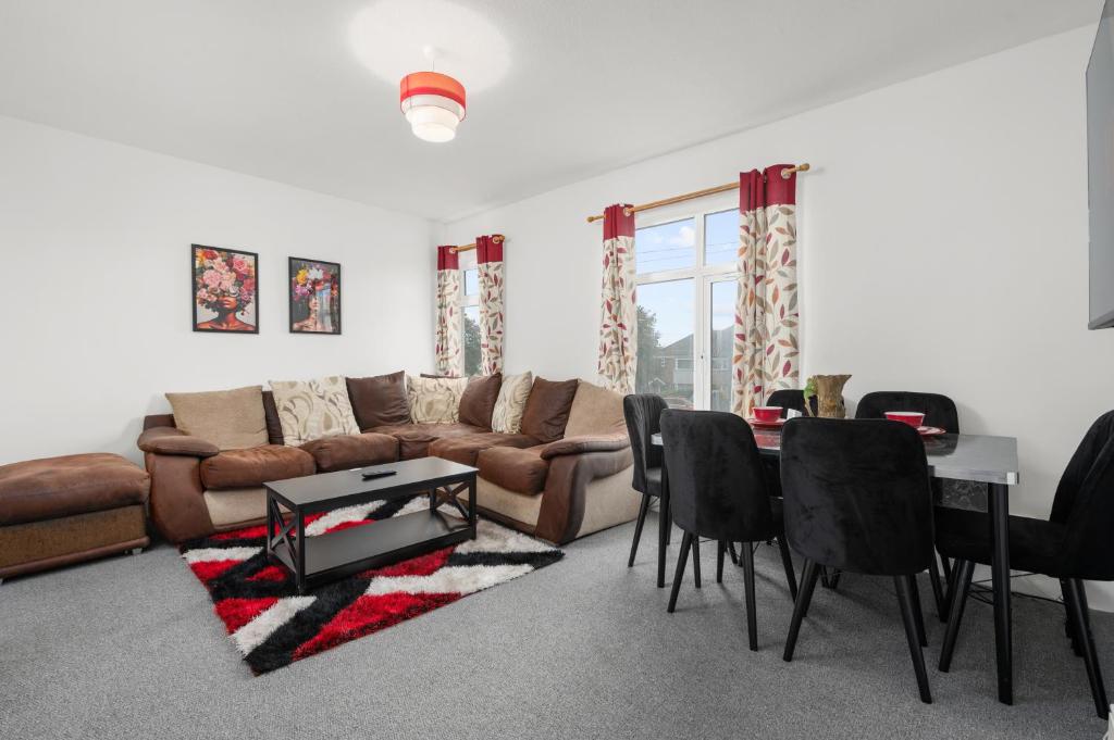 a living room with a couch and a table and chairs at Immingham Contractors stay in Immingham
