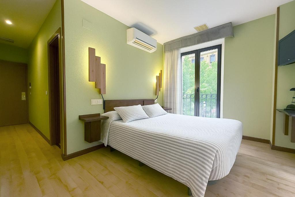 Postel nebo postele na pokoji v ubytování Hostal Concejo