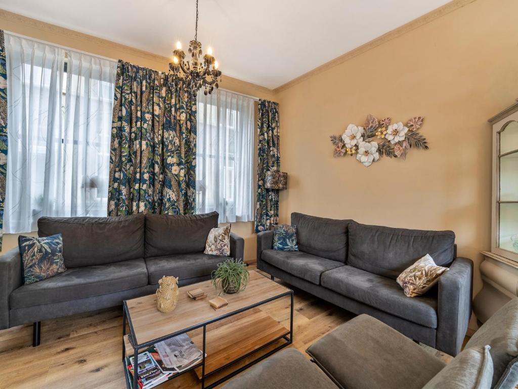 a living room with two couches and a table at Dog-Friendly Stay in Valkenburg in Valkenburg
