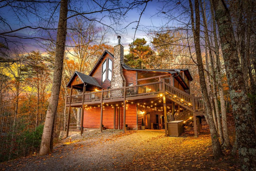a log cabin in the woods with a deck at Merlot Chateau - Views, New Hot Tub, Fire Pit, Game Room, Wi-Fi - Mins to Blue Ridge in Morganton