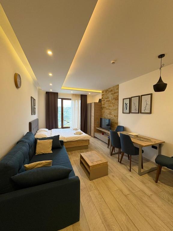 a living room with a couch and a table at Milmari apartman SAN-28 in Kopaonik