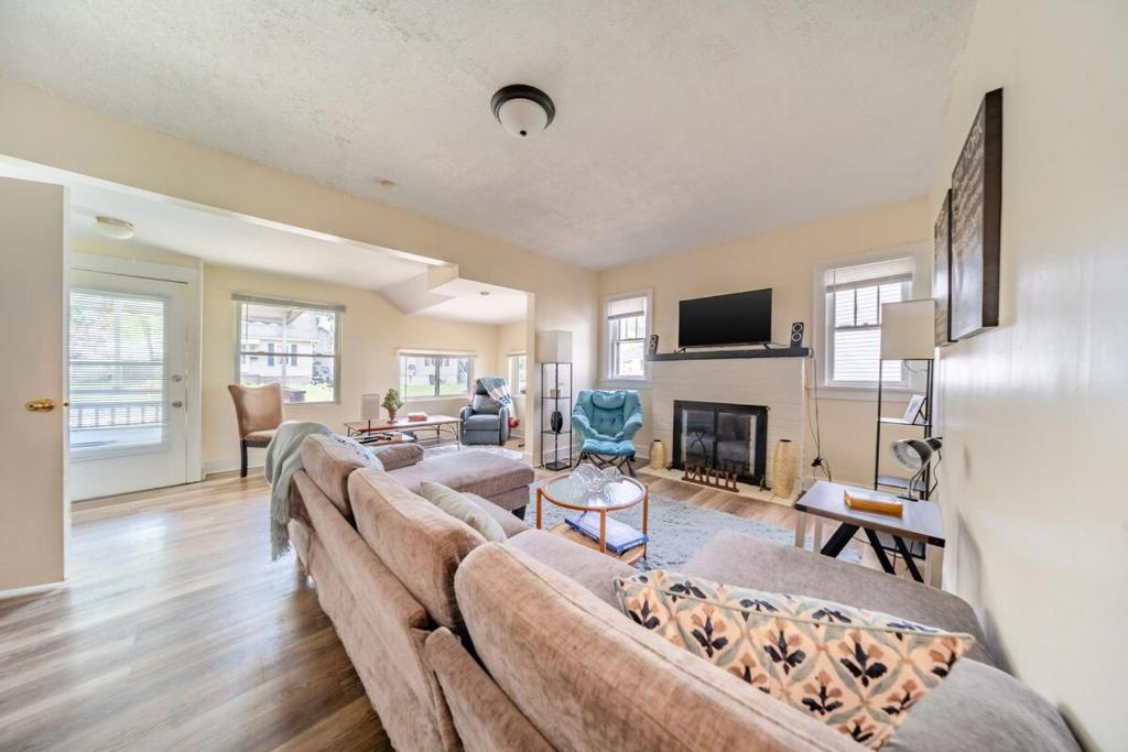 a living room with three couches and a fireplace at Cuyahoga Falls 3 bedroom 2 bath in Cuyahoga Falls