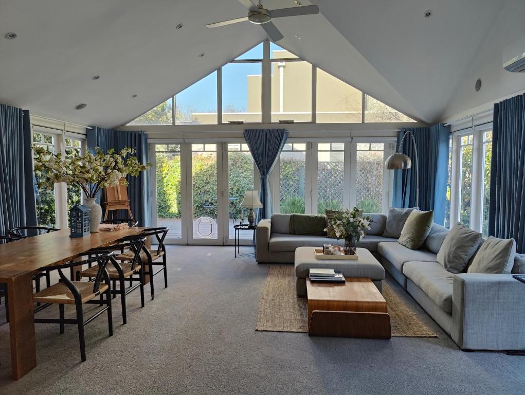 a living room with a couch and a table at Elegant Art Deco Gem Cosy 3BR Retreat in Carnegie