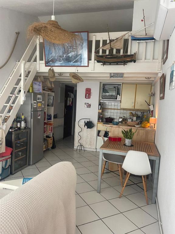 a kitchen with a table and a dining room at Petite Maison Cocooning in Leucate-Plage