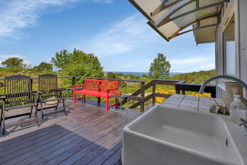 a deck with a sink and a table and chairs at 15515-Asnaes-Klintebakken-10 in Høve Strand