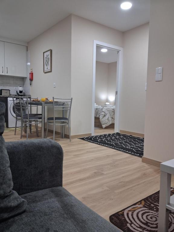 a living room with a couch and a table at Arco-Íris in Ponta do Sol