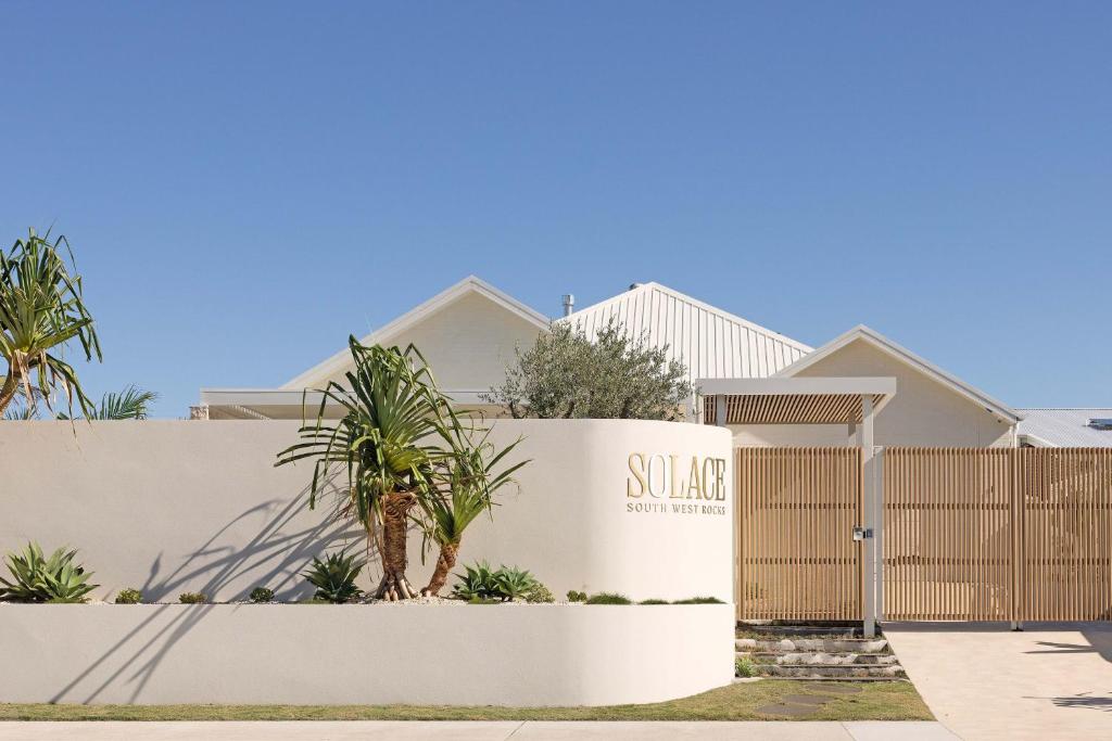 a building with a sign for a suburb at Private Beachside Escape – 5-Star Luxury for Families Friends in South West Rocks