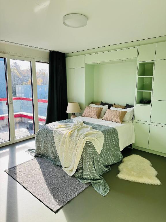 a bedroom with a large bed with a large mirror at Modern Living, Luxe Studio Zurich in Zurich
