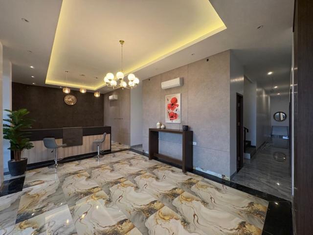 a large room with a large marble floor in a building at TJ Brother Residences Cengkareng in Jakarta