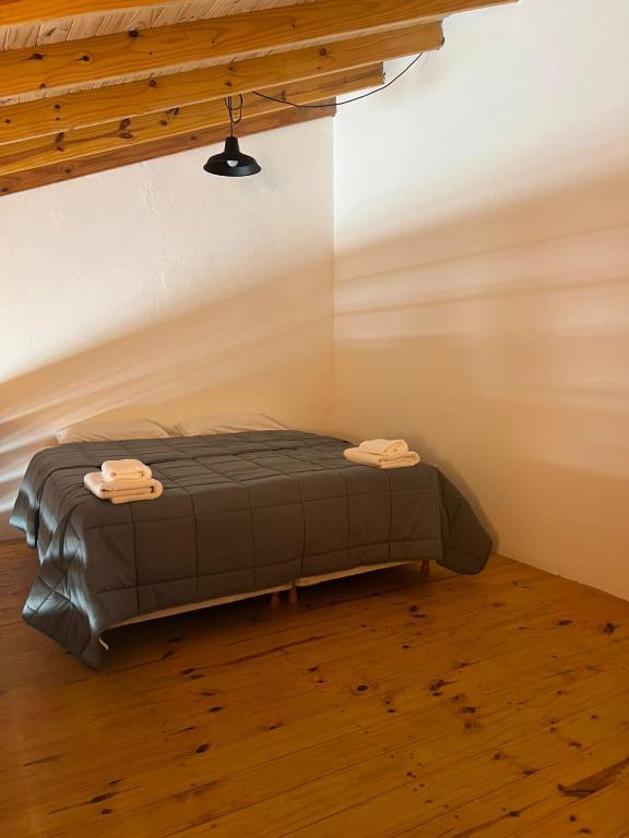 a bed in the corner of a room at Chalten Mountain Loft 8 in El Chalten