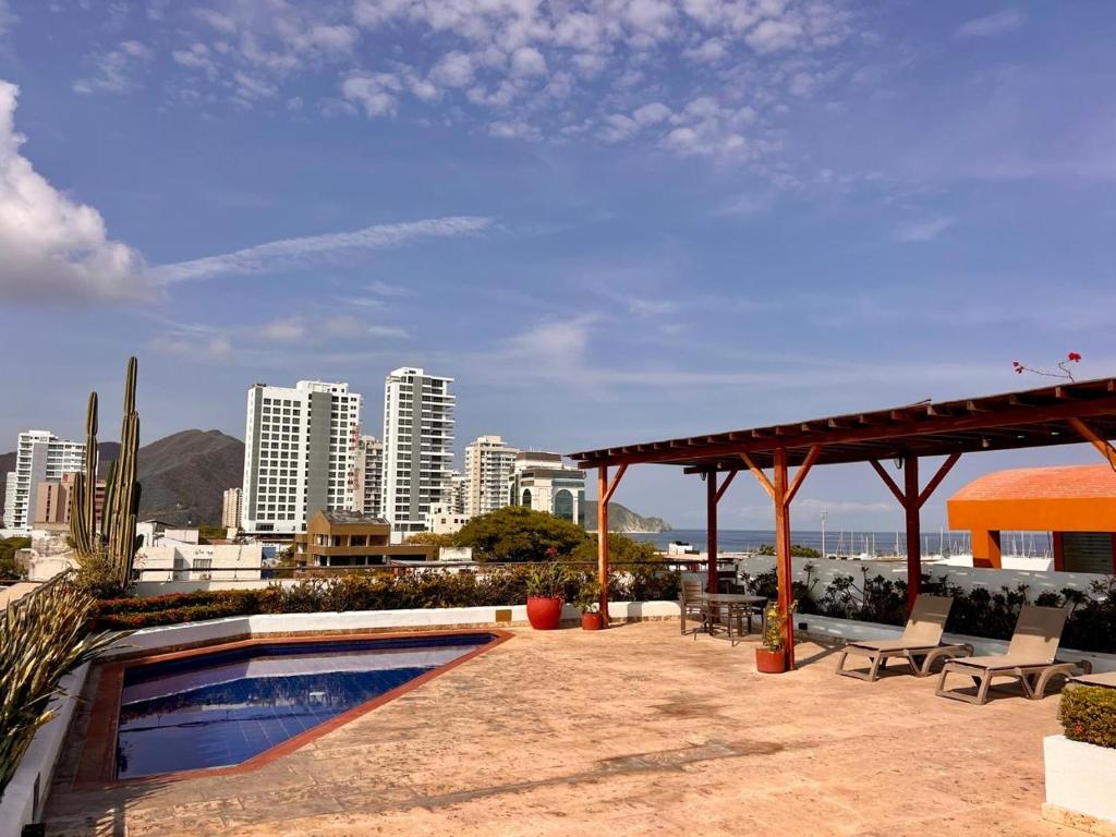 a swimming pool on a building with a view of a city at Luxury Boutique Apartments by Xarm Apartments in Santa Marta