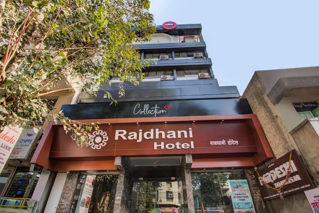a hotel sign in front of a building at Collection O Rajdhani Hotel in Pune