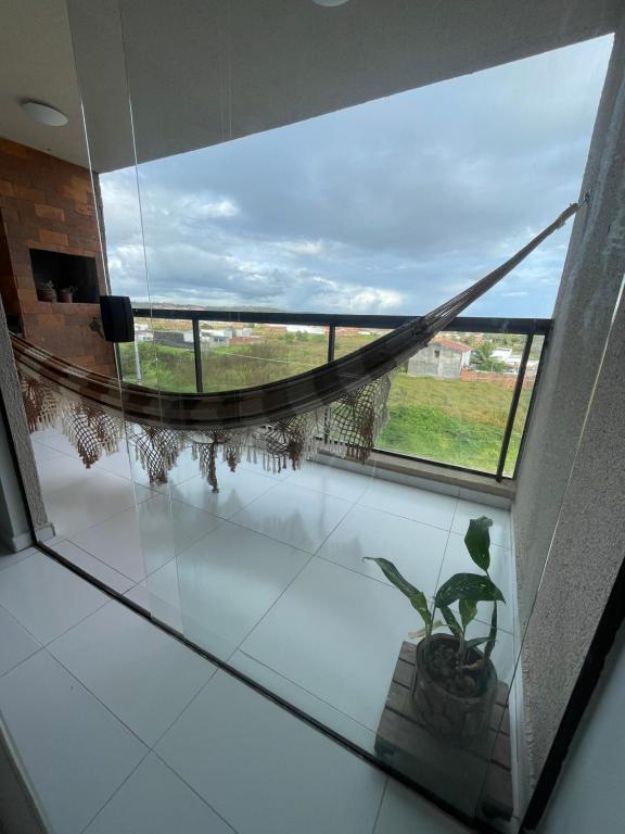 a room with a window and a potted plant at Ap 304 Via Mares do Frances in Marechal Deodoro