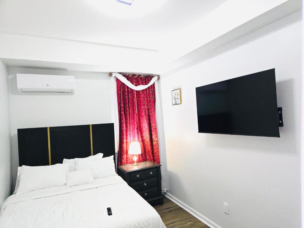 a bedroom with a bed and a flat screen tv at Home away from home in Elizabeth