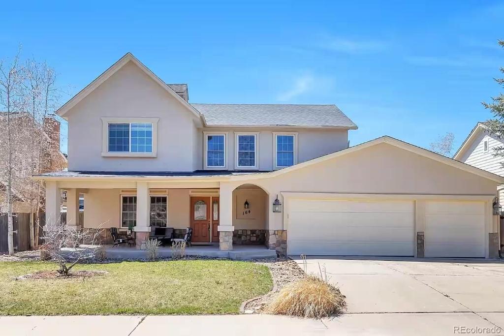 a white house with a garage at Spacious Country Club Golf Course Retreat in Broomfield