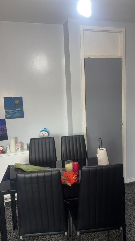 a dining room with two chairs and a table at Ayish in Birmingham