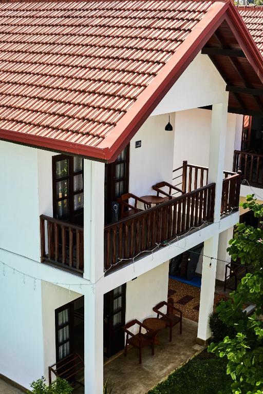 an outside view of a building with chairs and a balcony at Lum Residence in Ahangama