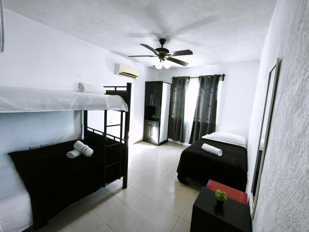 a bedroom with two bunk beds and a ceiling fan at well-deserved rest in Cancun in Cancún