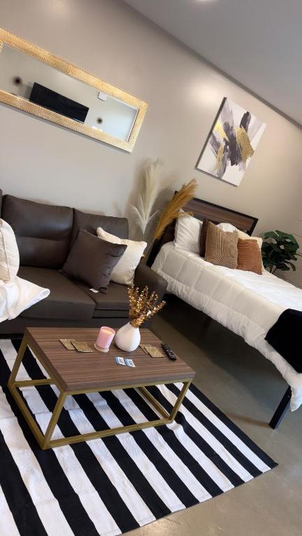 a living room with a couch and a coffee table at Opulent Oasis Located in The Heart of Birmingham in Birmingham