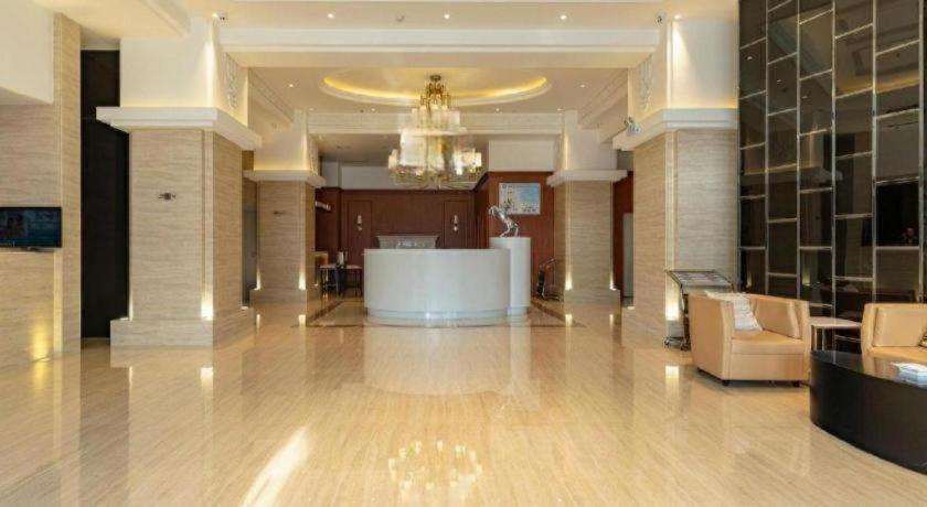 a large lobby with a chandelier in a building at Jinjiang Inn Select Hohhot Chengjisihan Square Metro Station in Hohhot